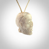 This photo shows a mummy skull pendant hand carved in deer antler. It is provided with a plaited cord necklace which is length adjustable.